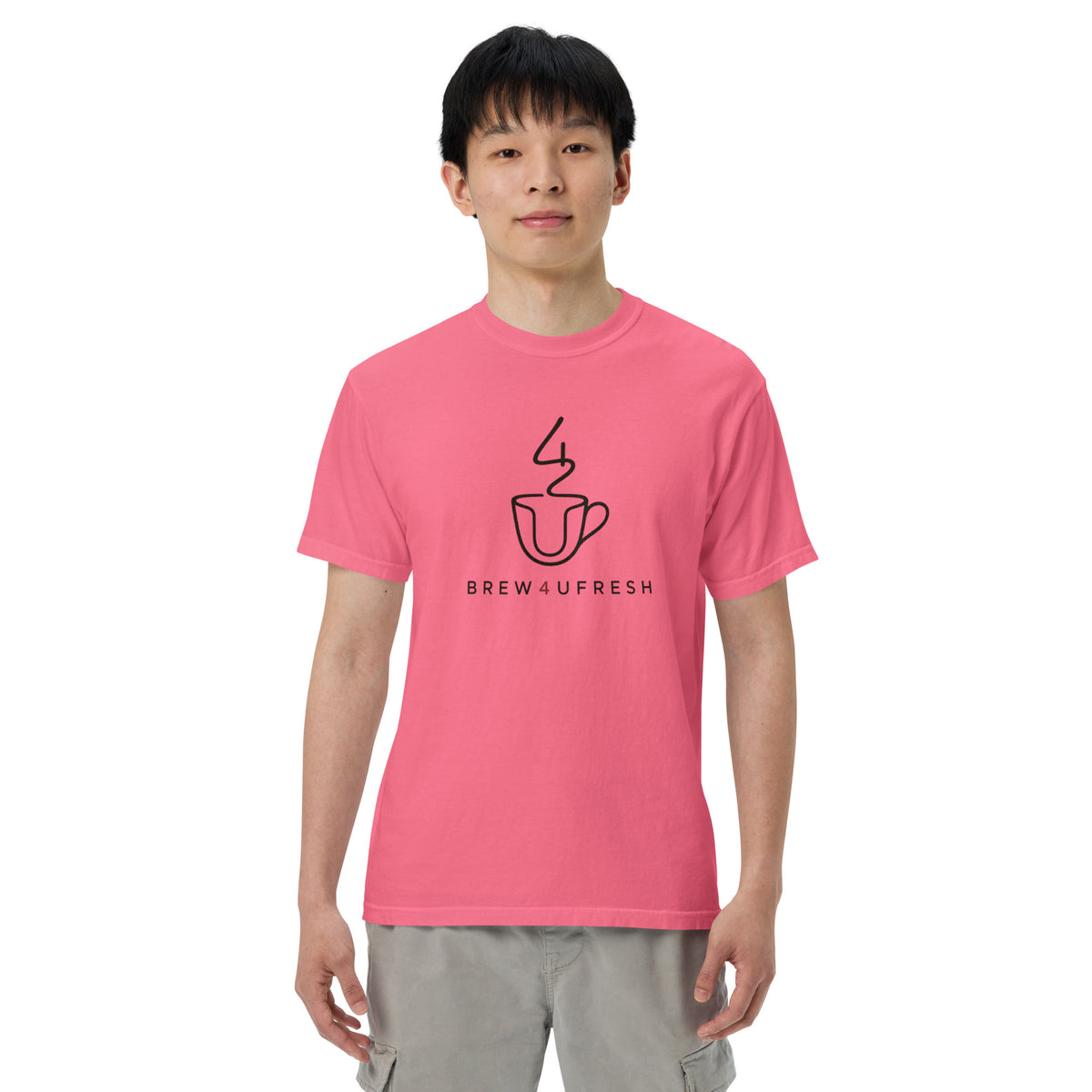 Unisex heavyweight tee in bright pink, made of 100% ring-spun cotton, featuring a black graphic logo on the front.
